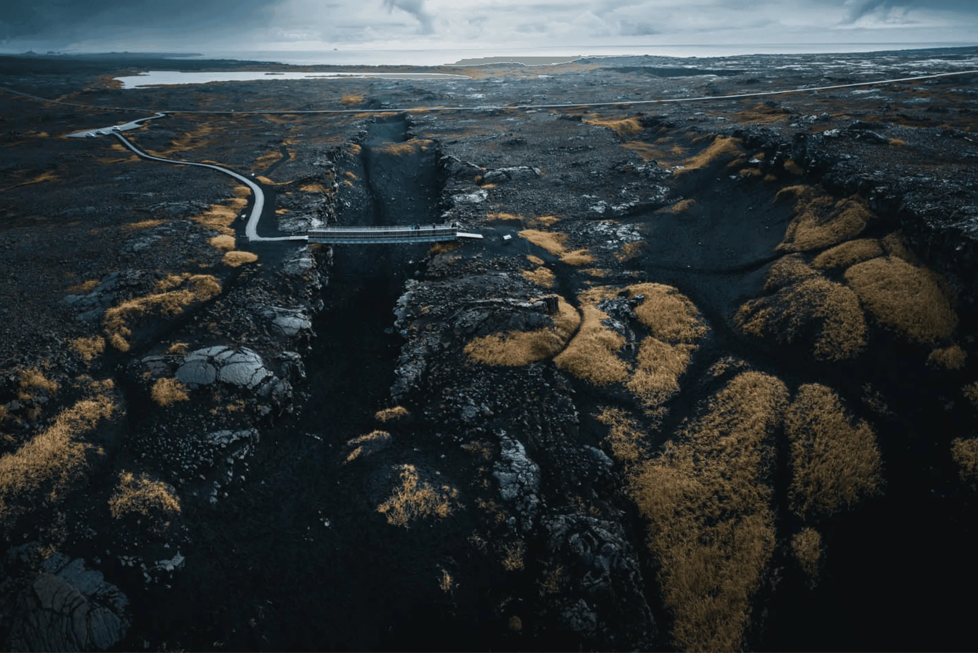 A small bridge crossing over the fissure where the Eurasian and North American tectonic plates divide on the Reykjanes Peninsula.