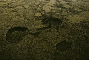 Dark green moss-covered lava fields on Iceland's Reykjanes peninsula sprawls out in all directions.