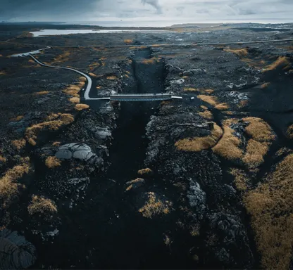 A small bridge crossing over the fissure where the Eurasian and North American tectonic plates divide on the Reykjanes Peninsula.