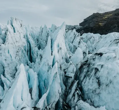 Sharp, blue tinted glacial formations on Falljökull glacier look like massive spikes of ice.