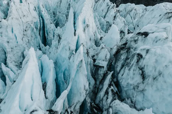 Sharp, blue tinted glacial formations on Falljökull glacier look like massive spikes of ice.